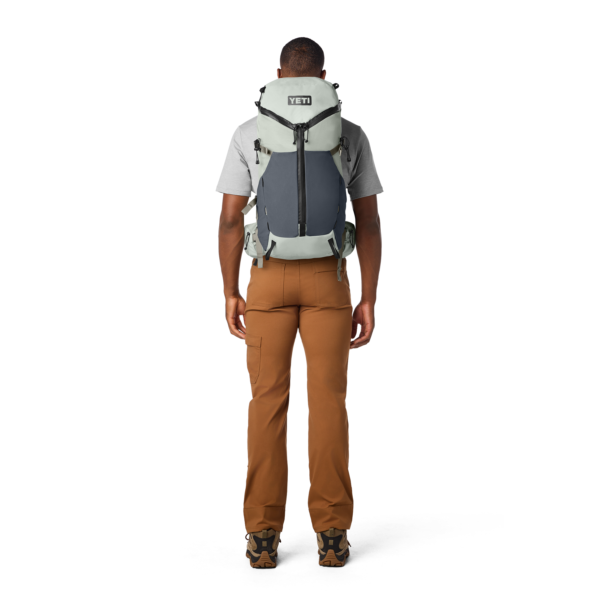 Person wearing a large backpack on a white background